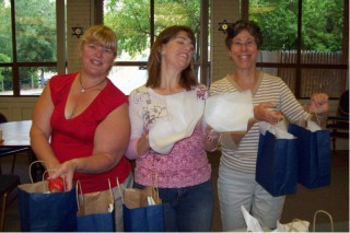 Women holding up Rosh Hashanah Bags
